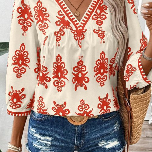 Oranje boho vintage blouse met geometrische print, 3/4 mouwen en V-hals.